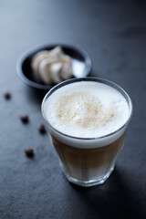 Coffee with milk on dark stone background. Close up.	