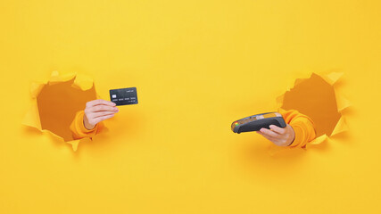 Close up cropped female hand hold wireless bank terminal to process acquire credit card payments pay isolated through torn yellow background studio Copy space place for text or image workspace mockup