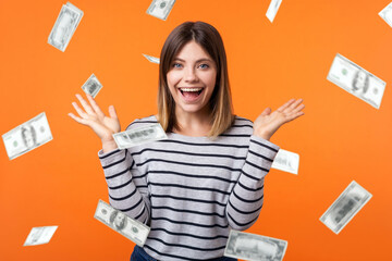 Money rain. Portrait of amazed beautiful young woman with brown hair in long sleeve striped shirt...