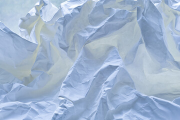 Obraz premium Crumpled paper against a window as an abstract background.