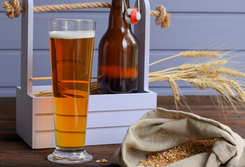 Home brewing concept. Make a lager beer with natural ingredients. Still life with beer and barley on wooden background