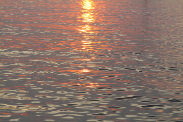 orange sunset on the sea, the setting sun is reflected in the water.