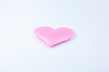 Pink heart on white background. Saint Valentine's day concept. Love and romantic photo. Postcard for holiday. Beautiful warm wallpaper with love. Soft focus. Copy space.