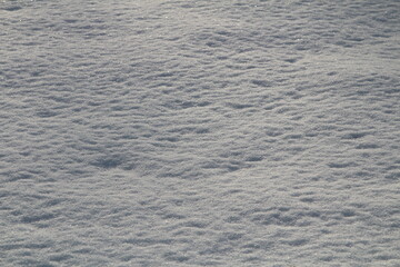 surface of thawed snow on a winter evening