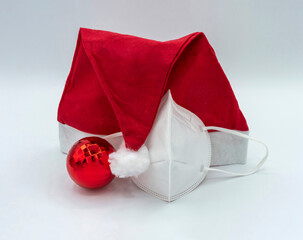 One Christmas tree ball Santa hat and protective mask