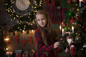 girl in a plaid dress at the Christmas tree