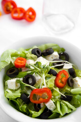 Delicious Salad with Black Olives and Feta Cheese in White Bowl