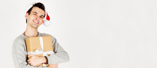 Man in Christmas hat hug gift box, holiday, christmas background