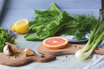 Fresh herbs, citrus fruits, spices on the table against the background of the window, organic products, healthy food, home seasonal cuisine