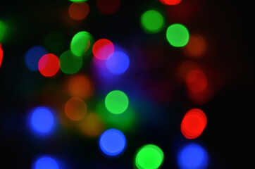 Abstract pattern of colorful bokeh lights on a dark background