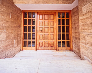 Obraz na płótnie Canvas Contemporary apartment building entrance natural wood and glass door, Athens Greece