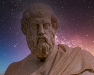 Plato the ancient Greek philosopher statue illuminated by starry night sky, Athens, Greece.