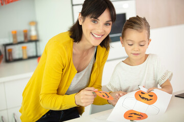 mother and daughter doing a craft activity at halloween