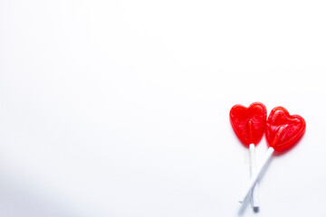Cenital plane. Two intertwined heart-shaped lollipops. Valentine and romantic love concept.