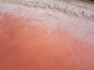 Fototapeta premium Aerial top view to pink salt lake. Photo from drone. Pink nature background. Sasyk-Sivash pink salt lake in Crimea.