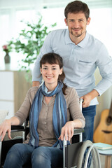 loving husband hugging handicapped wife at home