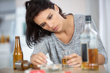depressed woman drinking alcohol alone at home