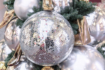Mirror disco ball and gold shoes on the Christmas tree.