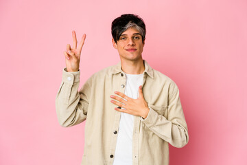 Young skinny hispanic man taking an oath, putting hand on chest.