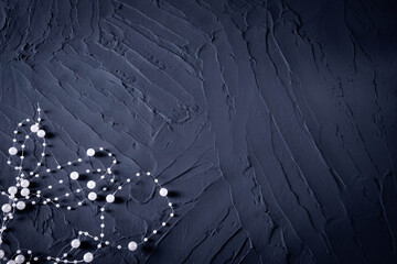 body jewelry in the form of beads on a dark blue rough background