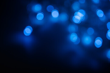 Abstract pattern of blue bokeh lights on a dark background