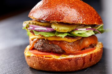 tasty burger with beef cutlet and vegetables