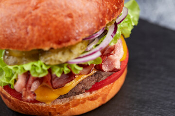tasty burger with beef cutlet and vegetables