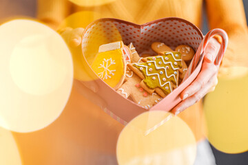box with gingerbread cookies in female hands