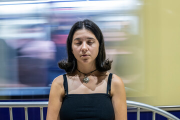 A girl daydreaming in the subway