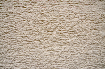 rough plaster facade painted yellow as a texture or background. High quality photo