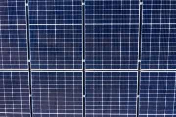Blue solar panels in a grid pattern on a residential roof