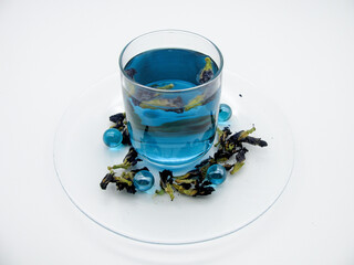blue anchan tea with triplicate clitoris flowers in a transparent glass Cup on a white background