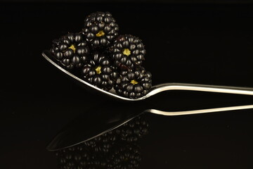 Ripe blackberries, close-up, on a black background.