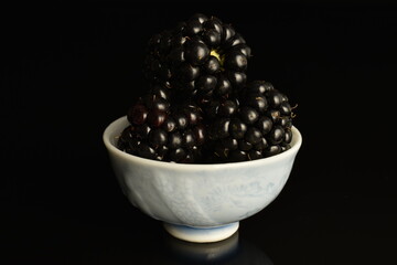 Ripe blackberries, close-up, on a black background.