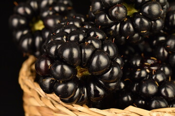 Ripe blackberries, close-up, on a black background.
