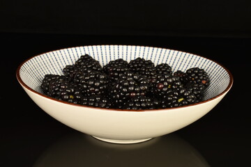 Ripe blackberries, close-up, on a black background.