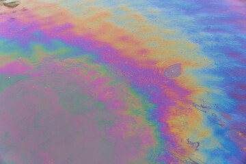 Fototapeta na wymiar Oil petrol water pollution. Ecological disaster. Slick industry oil fuel spilling water pollution. Water surface patches of gasoline and oil. Ecological catastrophy. Concept of environmental problems