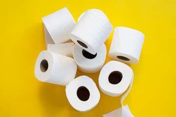 Toilet paper roll on yellow background.