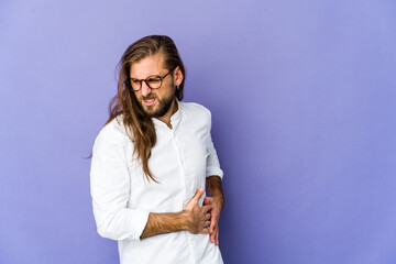 Young man with long hair look having a liver pain, stomach ache.