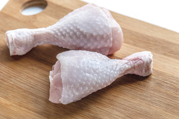 fresh raw chicken legs on a cutting board