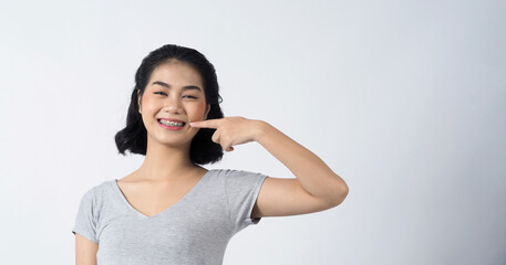 Dental braces of teen asian woman wearing braces teeth and contact lenses, she very confident and proudly present herself and smile on white background studio shot, Happiness teenager smiling facial 
