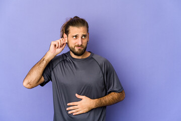 Young man with long hair look covering ears with fingers, stressed and desperate by a loudly...