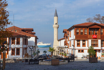 Fototapeta na wymiar Traditional ottoman houses (konak) and old mosque on the Degirmendere's seafront, Kocaeli, Turkey. Nice sunny day at winter