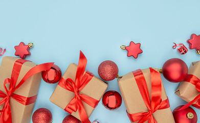 Christmas background with decorations and gift boxes on a light blue background. Paper gift boxes...