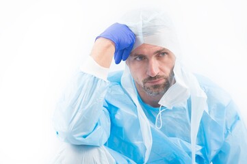 tired man doctor epidemiologist in safety protective costume on coronavirus pandemic quarantine isolated on white thinking about remedy, creating vaccine