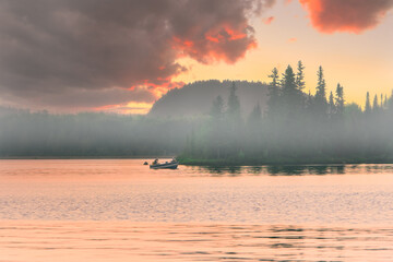 Sporty fishing boat on a lake with as background, Kekeko hill ( Rouyn-Noranda ), Quebec, Canada and...