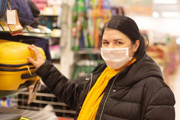 Fototapeta na wymiar Woman in protective mask, supermarket, things