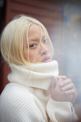 Young Blonde Asian Woman in White Turtleneck Sweater