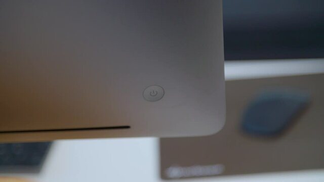 close up of a computer power button being activated