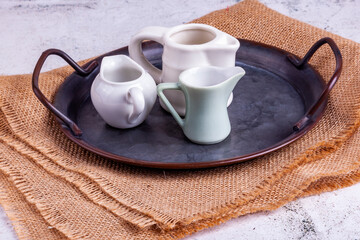 Three portion jugs for cream or milk on vintage metal tray